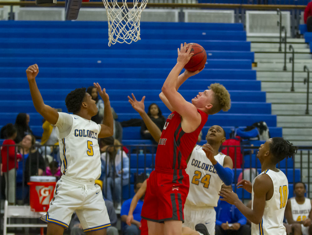 Lord Botetourt's (4) Kyle Arnholt goes up for the shot between William Fleming's defenders consisting of (5) Sae'Quan Bannister, (24) Donovan St. Juste and (10) Quavon Robertson.